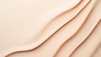 Neutral ivory geometric toned foundation forming fluid patterns, revealing silky cosmetic texture with graceful, sweeping movement across surface background photo