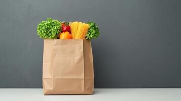 Various grocery items in paper bag on table opposite gray wall. food with fresh vegetables canned goods copy space for your text photo
