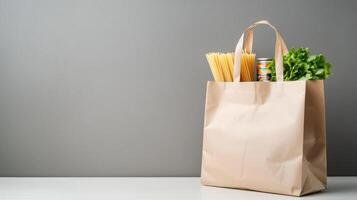 grocery items in paper bag table opposite gray wall. food with fresh vegetables canned goods copy space for your text photo