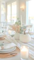 Minimalist autumn table setting with white pumpkins, candle and eucalyptus leaves creating a cozy atmosphere Minimalist Thanksgiving photo