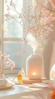 Ceramic essential oil diffuser releasing aromatic mist near blooming cherry branches, creating peaceful wellness atmosphere photo