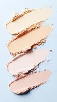 Foundation samples blending across surface, displaying gradient makeup palette for cosmetic compact powder design and artistic color transition photo