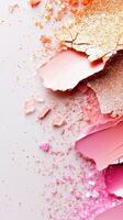 Crushed Macro cosmetic broken blush makeup in pink, gold, coral tones scattered across pristine white surface, forming vibrant, artistic texture photo