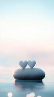 valentine Two white hearts resting on a rock in calm water during a beautiful sunset, creating a romantic and serene atmosphere background photo