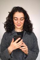 An isolated woman's portrait with a cell phone photo