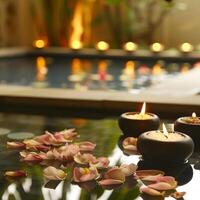 Serene spa ambiance with floating petals and glowing candles reflecting tranquility near a pool photo