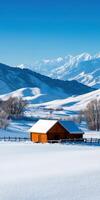 A small cabin is nestled in the snow in the mountains photo