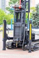 Powerful construction platform on caterpillar tracks with vertical stops and a high-altitude lifting mechanism. photo