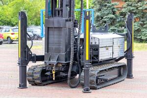 Construction platform on a rubber caterpillar track with a high-altitude lifting mechanism. photo
