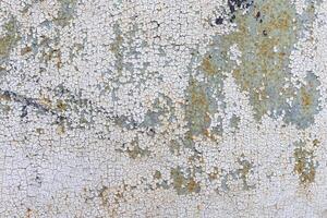 Close-up of an abstract pattern of old paint covering a wall. photo