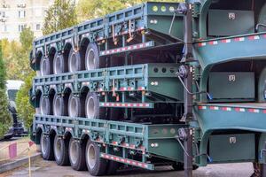 Wheeled trailer green platforms for trucks, stacked on top of each other. photo
