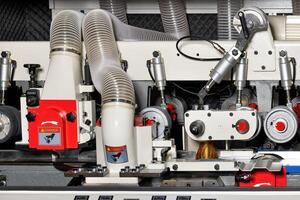 Precision woodworking machinery in action at a workshop during daytime operations photo