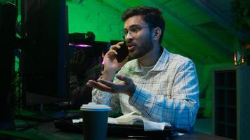 Stressed Arabian Indian man male guy looking code coder programmer technology talk mobile phone error hacker problem loss worker computer trouble IT specialist worried overwhelmed crypto currency work photo