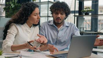 Professional mentor Arabian businesswoman help teach Indian worker analysis explain web project laptop difficult business quarrel conflict misunderstanding teamwork woman man use computer at office photo