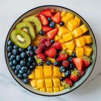 A round bowl with cut fruits white background product image photo