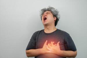 Man clutching his chest from acute pain and suffering from chest pain. Heart attack symptom-Healthcare and medical concept. healthcare and myocardial, angina, infarct, health problems concept photo