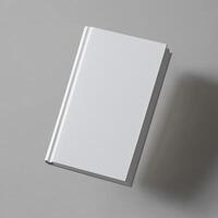 A blank white book floats against a gray background photo