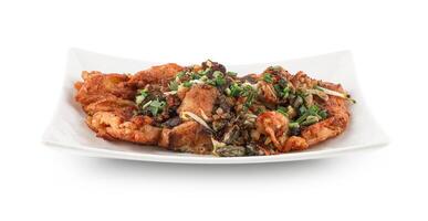Oyster Omelette isolated on the white background with clipping path, A popular Chinese Food in Thailand, fresh oyster mixed into an omelette and garnished with coriander leaves. photo