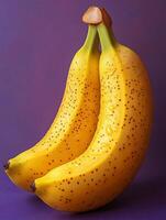 Two ripe bananas with speckles against a purple background. photo