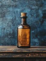 A brown glass bottle with a cork stopper resting on a wooden surface against a textured backdrop. photo