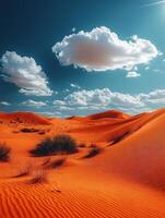 A vibrant desert landscape with orange dunes and fluffy clouds under a bright blue sky. photo