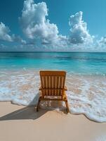 A wooden beach chair facing the ocean under a blue sky with fluffy clouds. photo