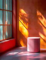 A minimalist interior scene with a pink stool, vibrant walls, and natural light patterns. photo