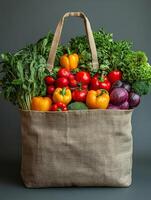 A burlap bag filled with fresh vegetables, showcasing a variety of colors and types. photo