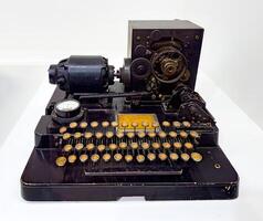 A unique vintage typewriter showcasing intricate internal gears and mechanisms, captured on a white background. Ideal for retro, industrial, or historical themes photo
