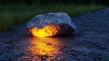 Glowing Lava Rock on Dark Ground at Dusk Nature Scene Surreal Image photo