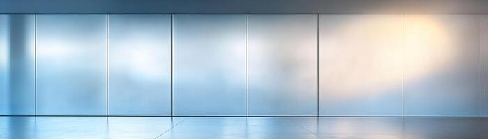 Frosted glass panels with a subtle blue tint catch soft light, casting delicate patterns across the smooth floor. The spacious area offers ample negative space for creative text integration photo