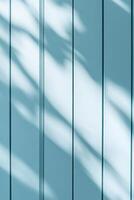 This abstract background features vertical grooves in soft light blue tones, enhanced by subtle shadows photo