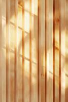 Vertical wooden slats create an abstract Nordic-style background enhanced by light patterns. The neutral backdrop allows for easy text overlay, offering a warm atmosphere photo