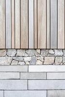 The backdrop showcases a harmonious blend of natural stone and wooden panels arranged in linear patterns. The muted tones create a soothing and elegant atmosphere ideal for various design projects photo