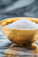 A luxurious crystal sugar set in a shining gold-plated bowl rests on a polished marble surface. The high-end presentation highlights glamour and sophistication with ample space for text photo
