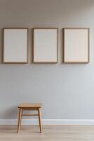 Three empty frames of varying sizes create a minimalist gallery wall against a light gray background. The natural wood and white finishes highlight modern decor, perfect for personalization photo