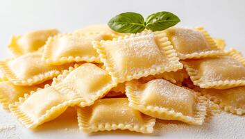 A stack of pasta with a green leaf on top. The pasta is made of wheat and is white in color. The leaf is fresh and green, and it is placed on top of the pasta. The pasta is arranged in a neat pile photo