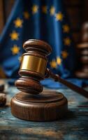A gavel is on a wooden base in front of a flag. The flag is blue and has stars photo