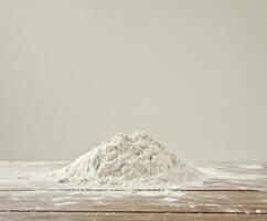 Flour pile on wooden surface with soft lighting creating an inviting atmosphere for baking activities photo