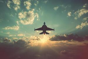 Fighter jet soaring above clouds at sunset creating a dramatic sky filled with warm hues and light photo