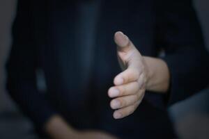 usiness hand reaching out for a handshake, representing partnership, trust, and collaboration in teamwork photo