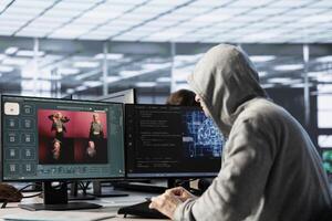 Engineer in data center making generative artificial intelligence website generating videos using diffusion model algorithms. Hooded man coding AI virtual assistant producing clips photo