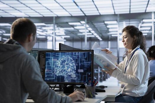 Manager looking over paperwork in machine learning server farm to ensure compliance with industry standards and regulatory requirements. Supervisor overseeing data center security protocols photo