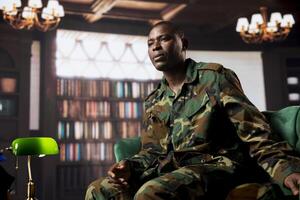 African american soldier in counseling for PTSD syndrome talking to a therapist, discussing combat trauma and losing colleagues. Therapy session and rehabilitation for military veterans. photo