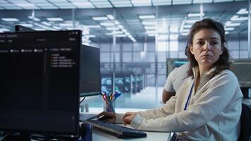 Portrait of smiling technician using PC to do maintenance on artificial intelligence neural networks. Cheerful admin using AI system aiding in processing and transmitting information, camera B photo