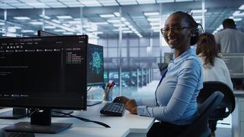 Portrait of happy computer scientist programming in AI data center used for machine learning training. Joyful IT professional working on artificial intelligence tech in server hub office, camera B photo