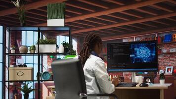 Teleworking programmer using computer for artificial intelligence computing through self learning algorithms. Remote worker working with AI deep neural networks on desktop PC, camera A wide angle shot photo