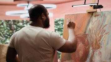 In a creative workshop, artist mixes pigments to achieve the perfect dye shade. Using professional art supplies to create a beautiful masterpiece on canvas, quality time in atelier. Camera A. photo
