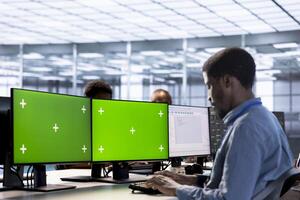 Software developer in data center using diagnostic tools on multi monitor mockup PC to identify root cause of errors. IT expert working in server room on isolated screen computer, repairing gear photo