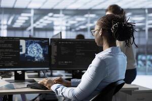 Woman typing on computer in server hub, monitoring data center energy consumption using AI software. Engineer managing supercomputers in server room using artificial intelligence tech photo